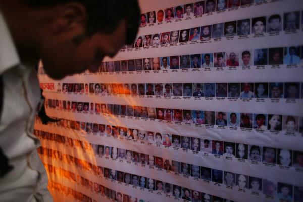 Man looks at victims' memorial.